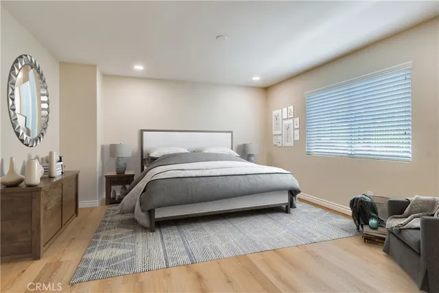 an empty room with wooden floor and a window