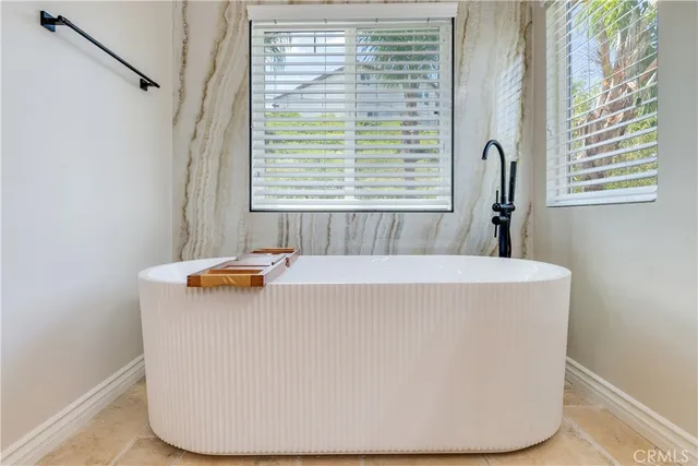 a bathroom with a sink a toilet a tub and shower