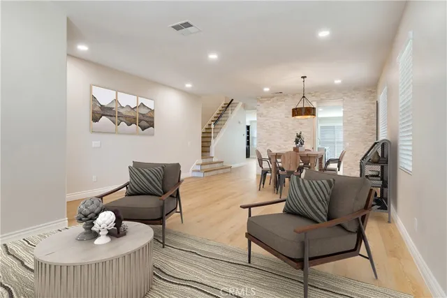 an empty room with wooden floor and ceiling fan