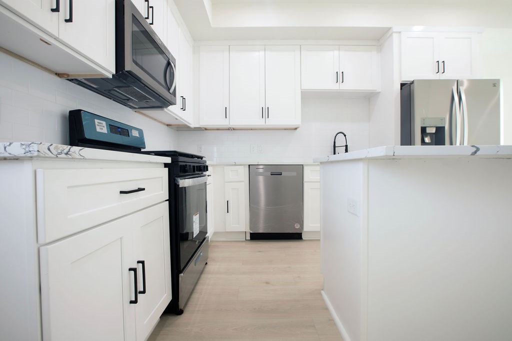 4137 Mallow Street, Unit A Houston, TX 77051 - Photo 15 of 16 a kitchen with stainless steel appliances a refrigerator sink and cabinets