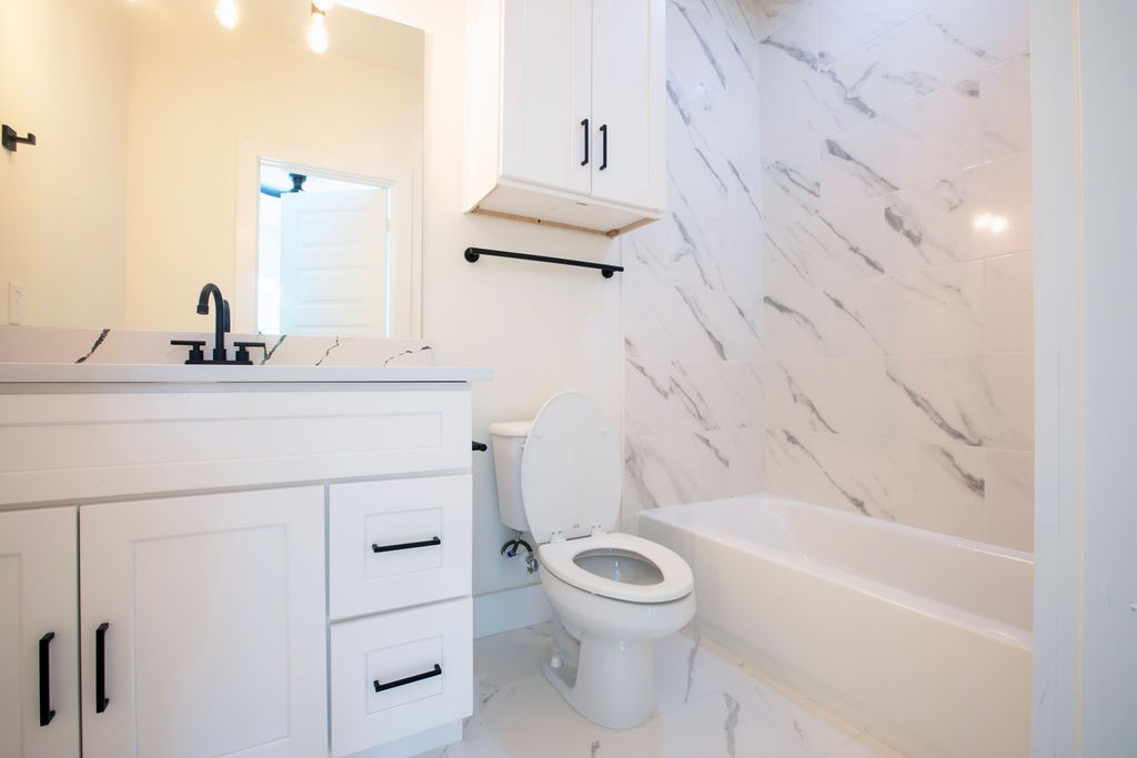 4137 Mallow Street, Unit A Houston, TX 77051 - Photo 8 of 16 a bathroom with a sink a toilet and vanity