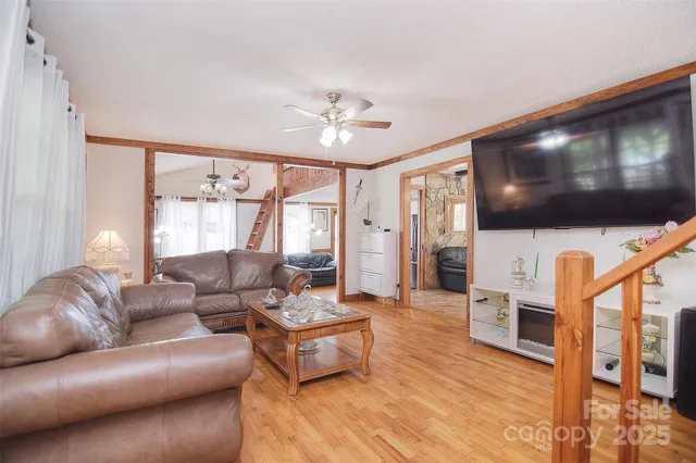a living room with furniture a dining table and wooden floor