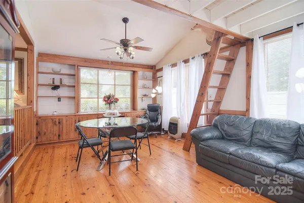 a living room with lots of furniture and a large window
