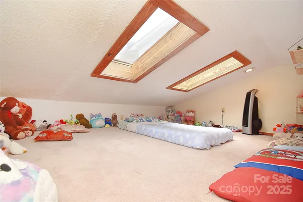 a kitchen with a stove a sink dishwasher a dining table and chairs with wooden floor