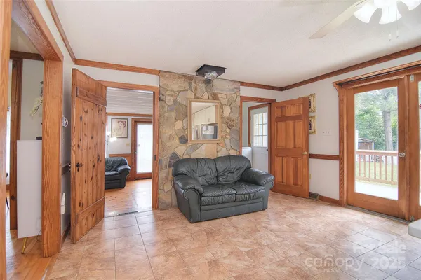 a dining room with furniture a chandelier and wooden floor