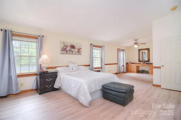 a bed room with a bed and a view of kitchen
