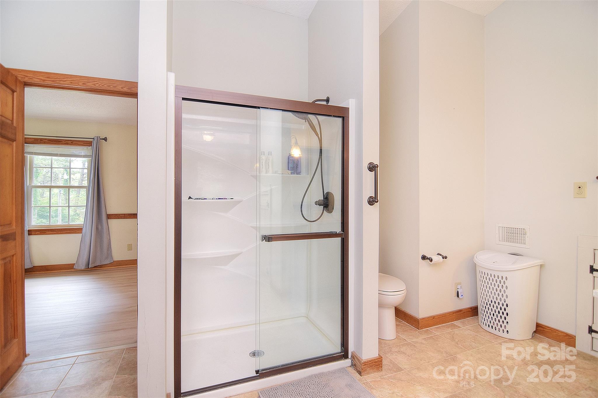 109 Larch Road Salisbury, NC 28147 - Photo 28 of 43 a bathroom with a glass shower door and a toilet