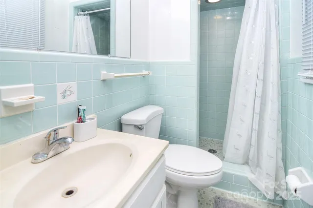 a bedroom with a bed and a flat tv screen on the dresser