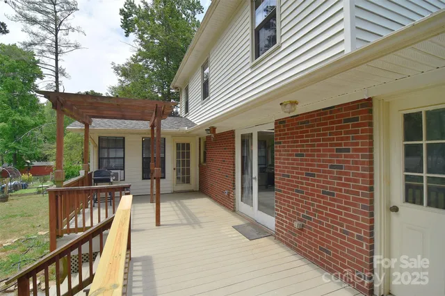 a view of a patio with a table chairs and a backyard