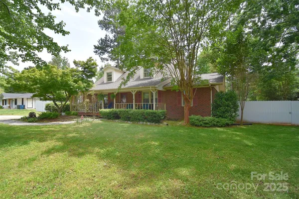 a view of a house with backyard and porch
