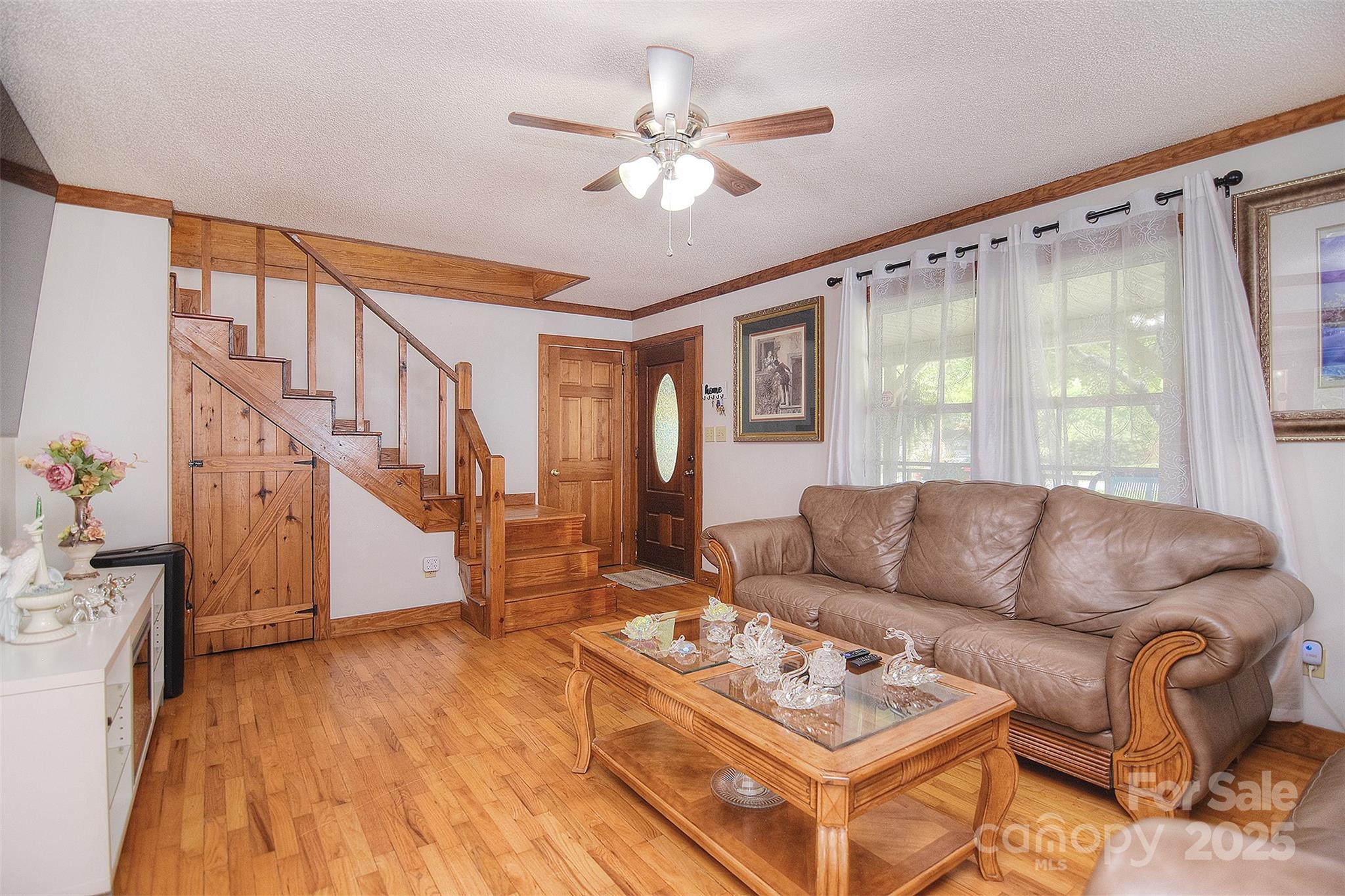 109 Larch Road Salisbury, NC 28147 - Photo 10 of 43 a living room with furniture and a large window with wooden floor