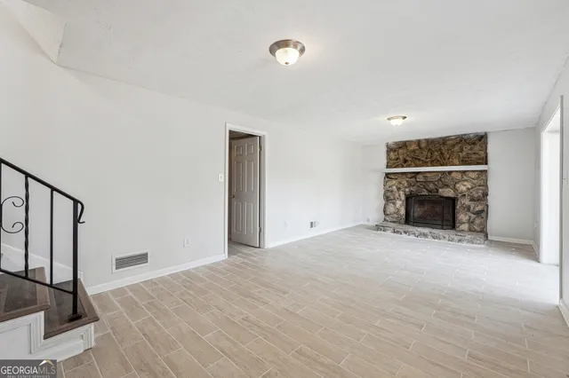 a view of empty room with fireplace