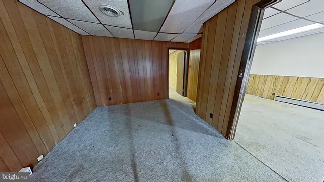 a view of a room with a wooden door