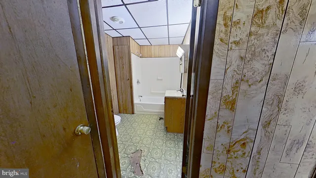 a bathroom with a granite countertop shower and a sink