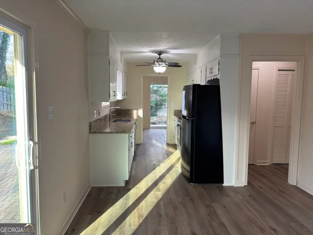 a kitchen with a refrigerator and a sink
