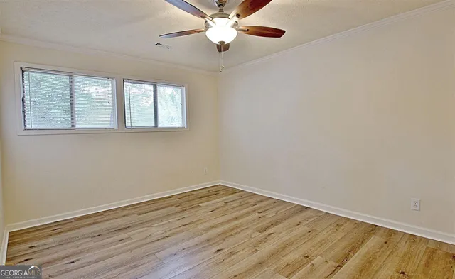 wooden floor in an empty room with a window