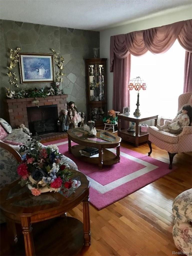3961 Washburn Road Vassar, MI 48768 - Photo 9 of 25 A great view of the formal living room with hardwood flooring and the electric fireplace stays.