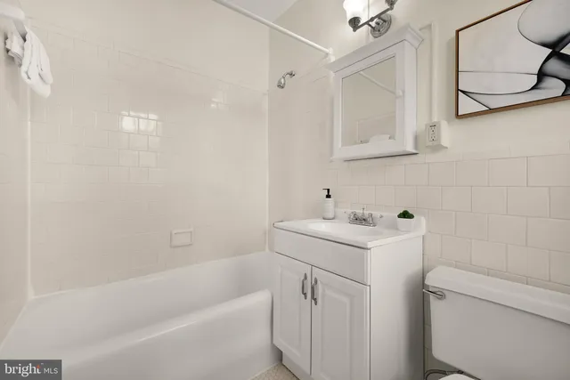 a bathroom with a sink a toilet and bathtub
