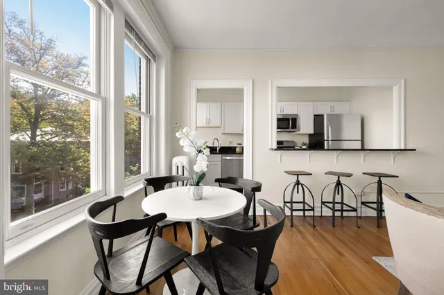 a dining room with furniture and wooden floor