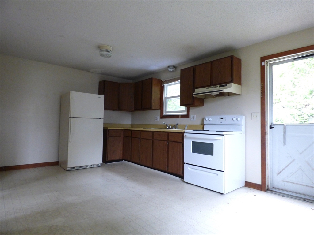 16-18 Daniel Street Springfield, MA 01151 - Photo 4 of 14 a kitchen with stainless steel appliances a refrigerator stove and microwave