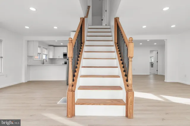 a view of entryway and hall with wooden floor