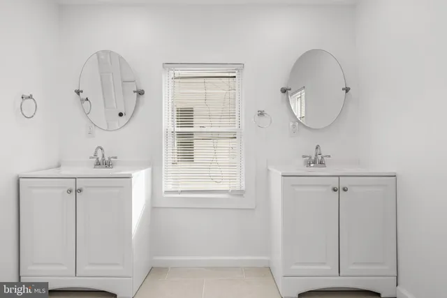 a bathroom with 2 sink and a mirror