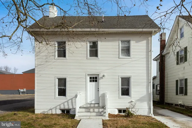 a view of a white house with a large windows