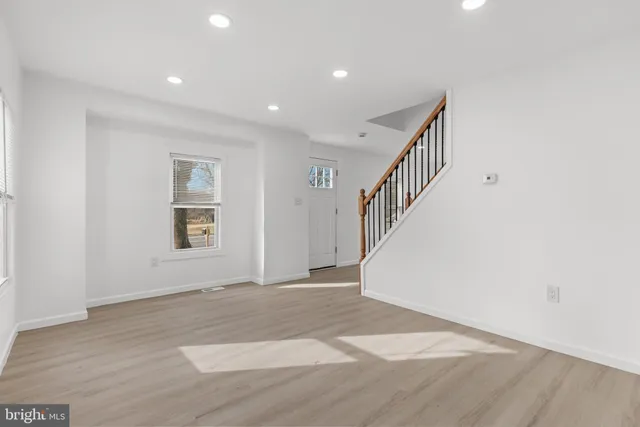 a view of an entryway with wooden floor