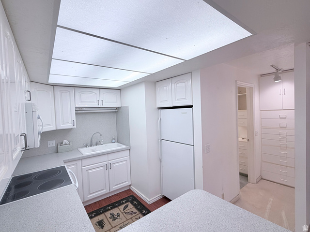 2855 South 1000 West Perry, UT 84302 - Photo 125 of 142 Kitchen featuring white cabinets, light countertops, white appliances, and dark wood-style floors