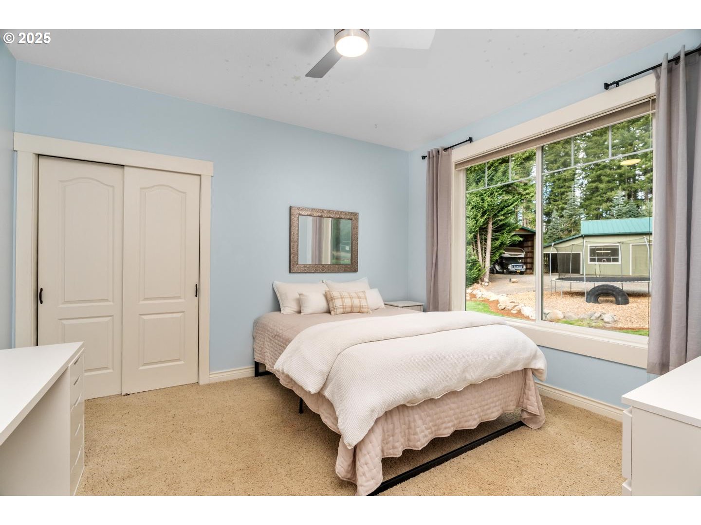 21481 South Ridge Road Oregon City, OR 97045 - Photo 21 of 48 a bedroom with a large bed and a large window