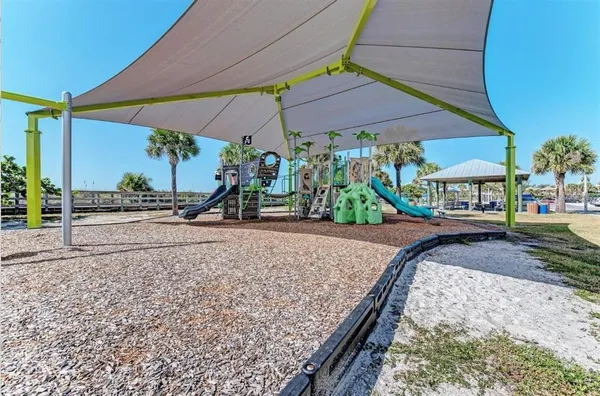 a view of outdoor space with playground and green space