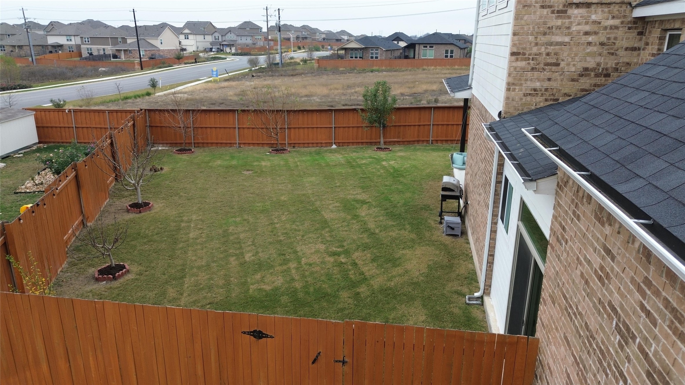 650 Wild Pecan Loop Buda, TX 78610 - Photo 5 of 28 Fenced backyard featuring a residential view