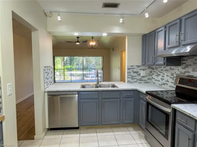a kitchen with a sink stove and cabinets