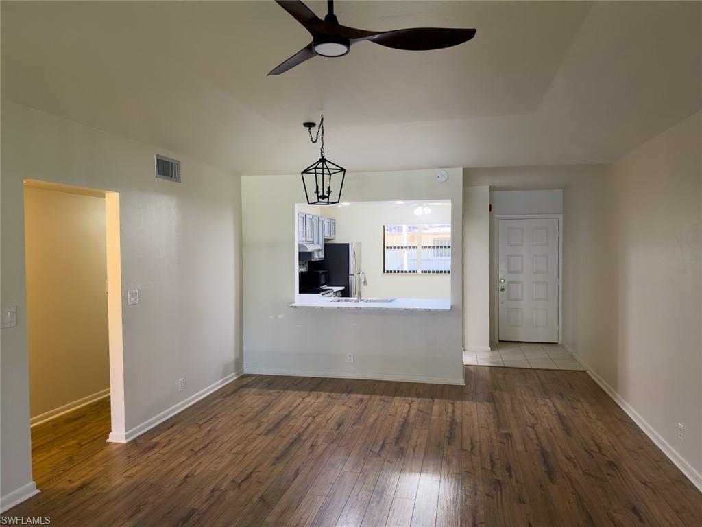 1801 Courtyard Way, Unit D201 Naples, FL 34112 - Photo 12 of 37 a view of empty room with wooden floor and window