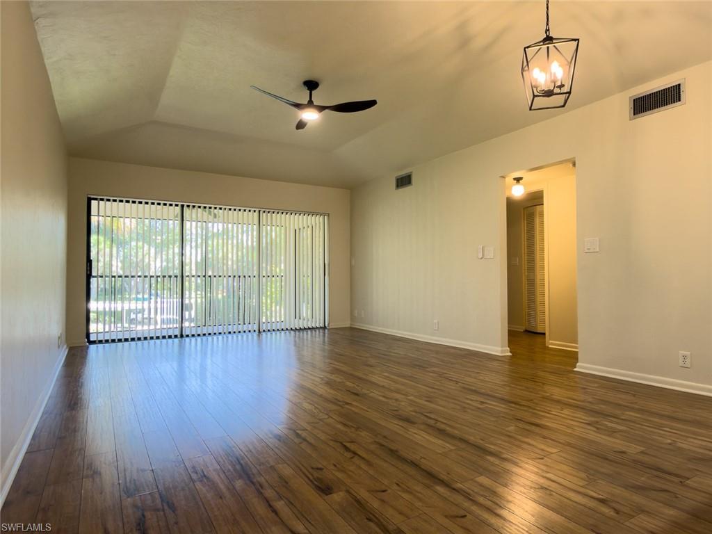 1801 Courtyard Way, Unit D201 Naples, FL 34112 - Photo 13 of 37 wooden floor in an empty room with a window