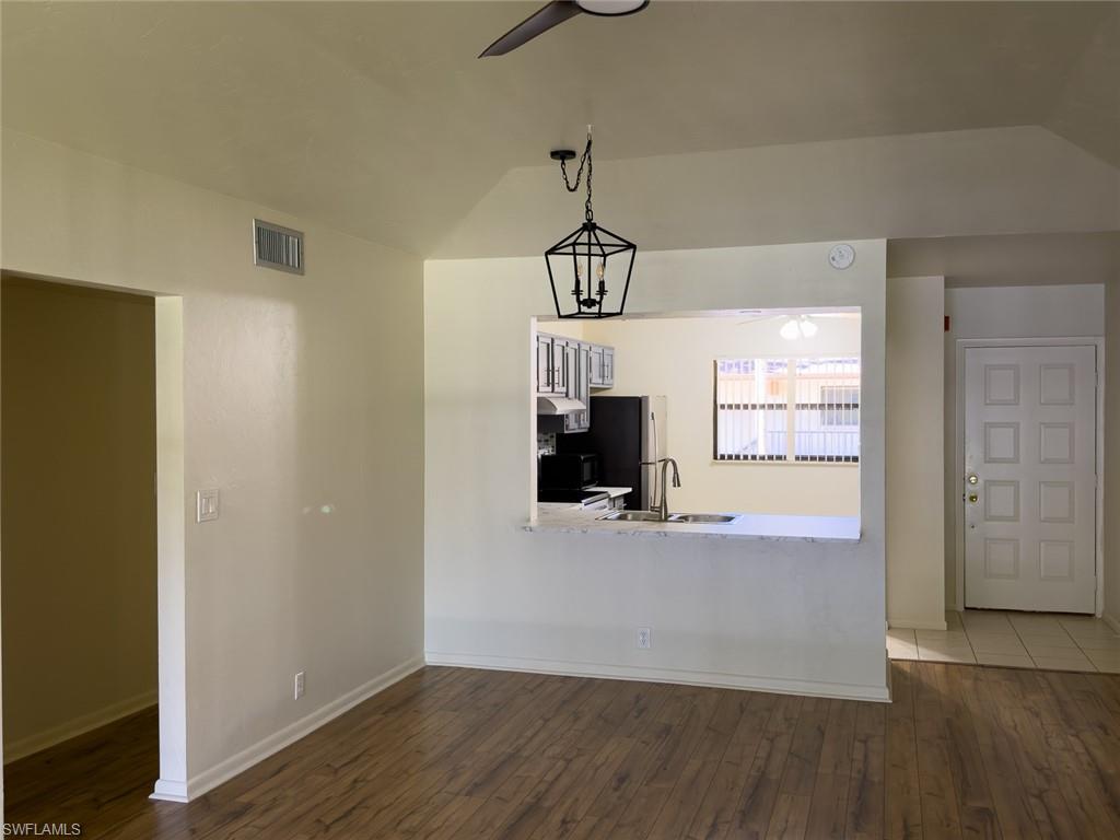 1801 Courtyard Way, Unit D201 Naples, FL 34112 - Photo 14 of 37 a view of empty room with wooden floor