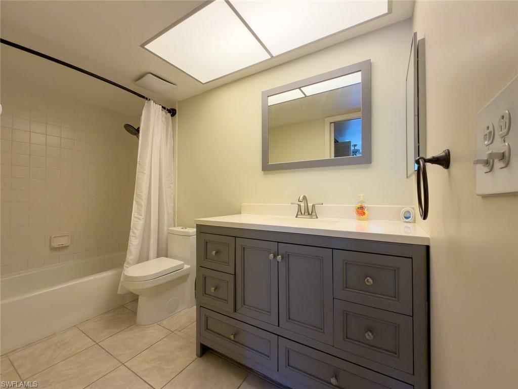 1801 Courtyard Way, Unit D201 Naples, FL 34112 - Photo 18 of 37 a bathroom with a sink toilet and shower