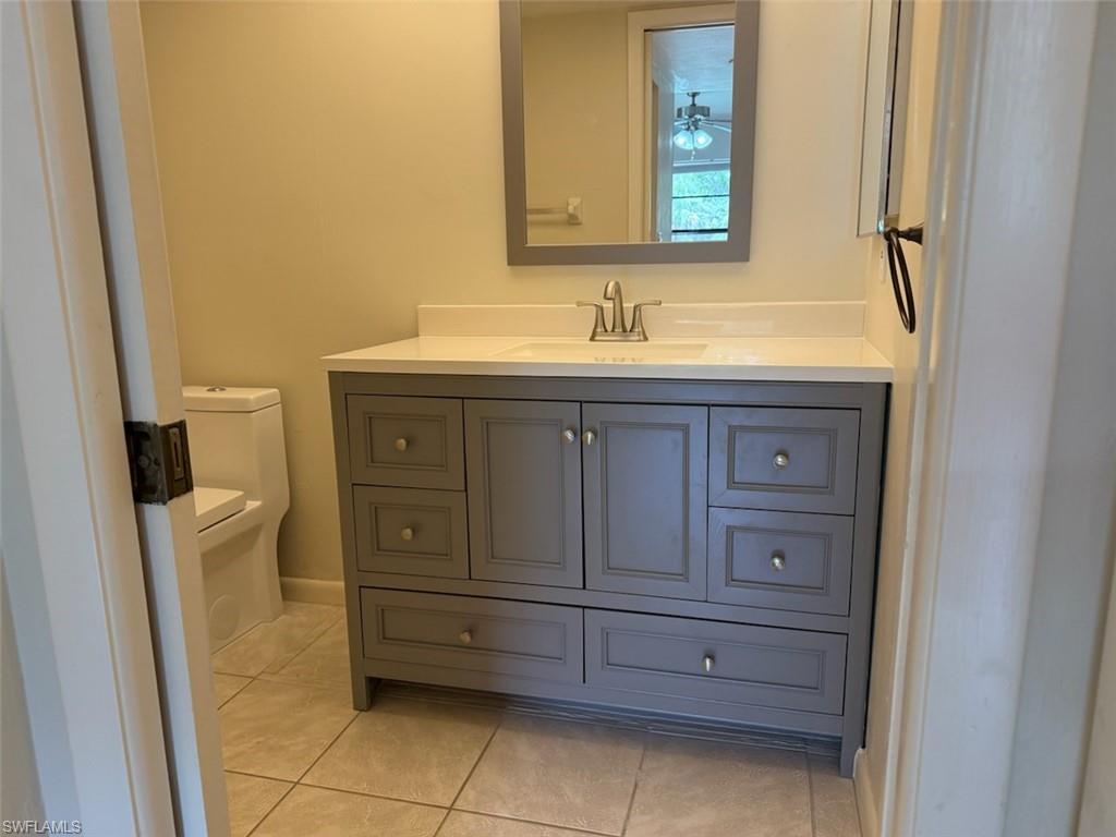 1801 Courtyard Way, Unit D201 Naples, FL 34112 - Photo 19 of 37 a bathroom with a sink and a mirror