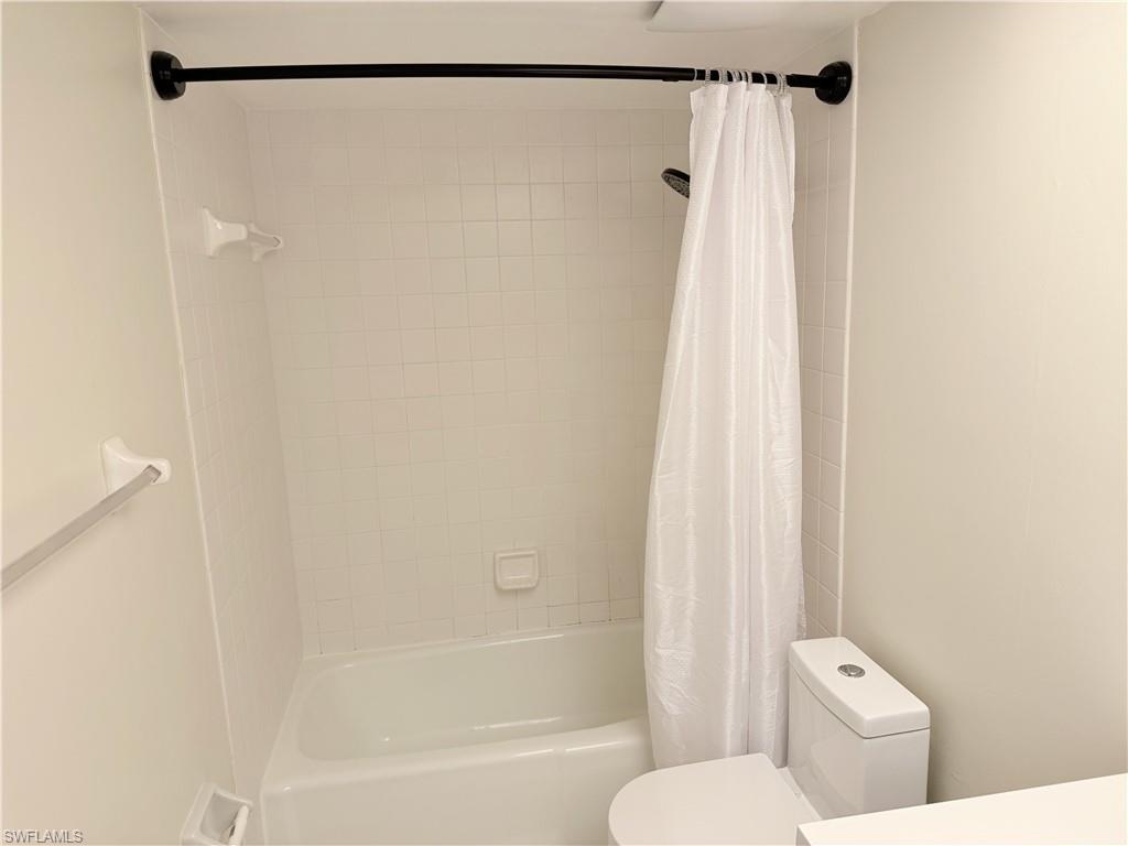 1801 Courtyard Way, Unit D201 Naples, FL 34112 - Photo 21 of 37 a bathroom with a shower and a toilet
