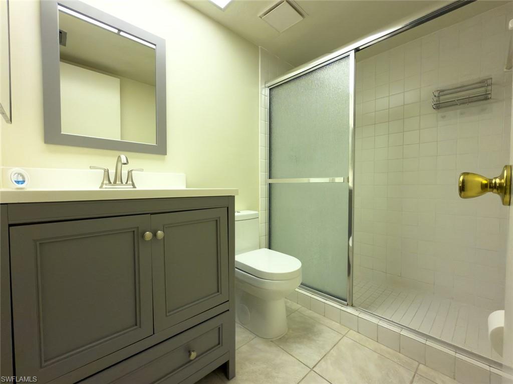 1801 Courtyard Way, Unit D201 Naples, FL 34112 - Photo 23 of 37 a bathroom with a sink toilet and shower