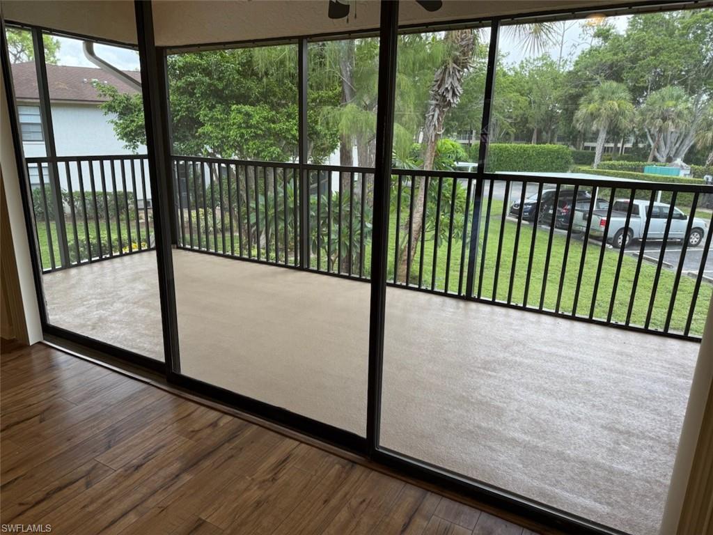 1801 Courtyard Way, Unit D201 Naples, FL 34112 - Photo 24 of 37 a view of a porch with wooden floor