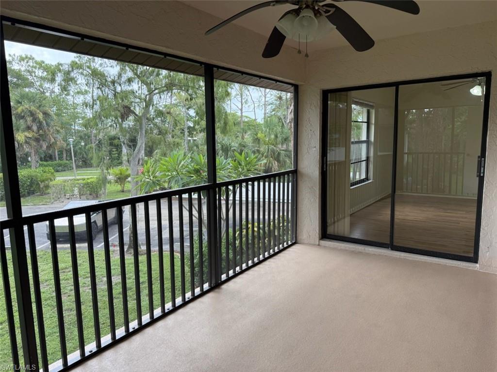 1801 Courtyard Way, Unit D201 Naples, FL 34112 - Photo 28 of 37 a view of a porch with a floor to ceiling window