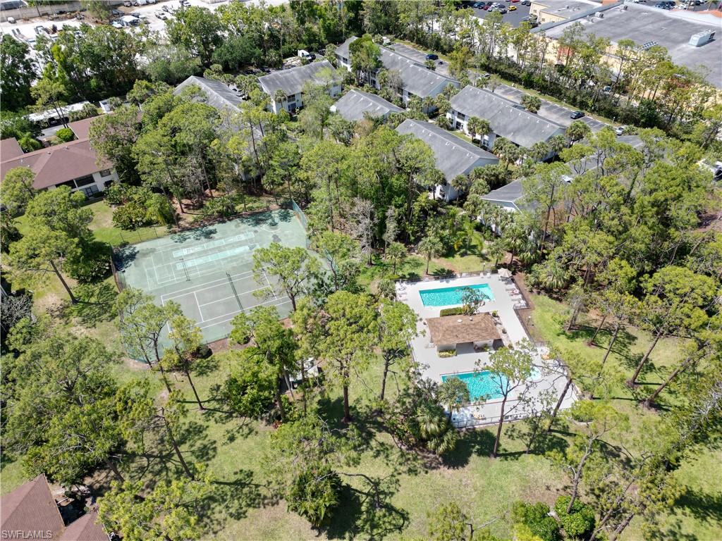 1801 Courtyard Way, Unit D201 Naples, FL 34112 - Photo 30 of 37 an aerial view of residential house with outdoor space and trees all around