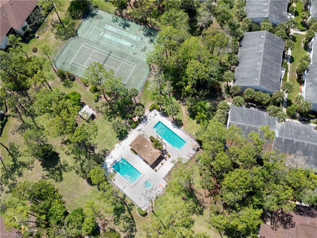 1801 Courtyard Way, Unit D201 Naples, FL 34112 - Photo 31 of 37 an aerial view of a house with a yard and garden