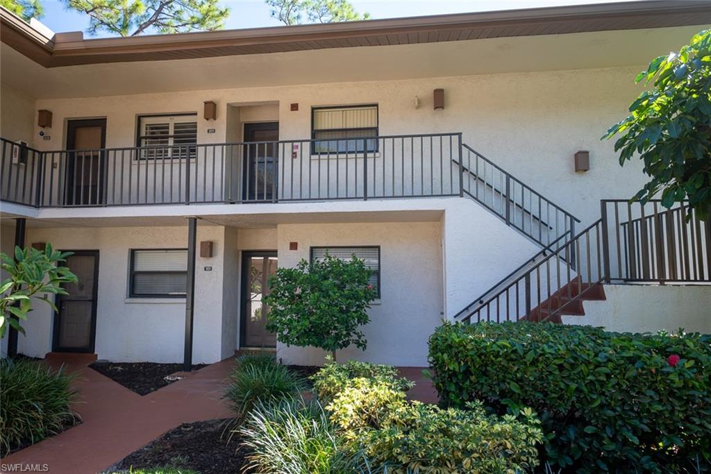 1801 Courtyard Way, Unit D201 Naples, FL 34112 - Photo 33 of 37 a view of front door with potted plants