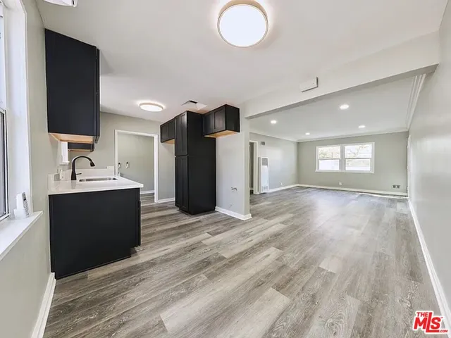 a view of kitchen and hall with wooden floor
