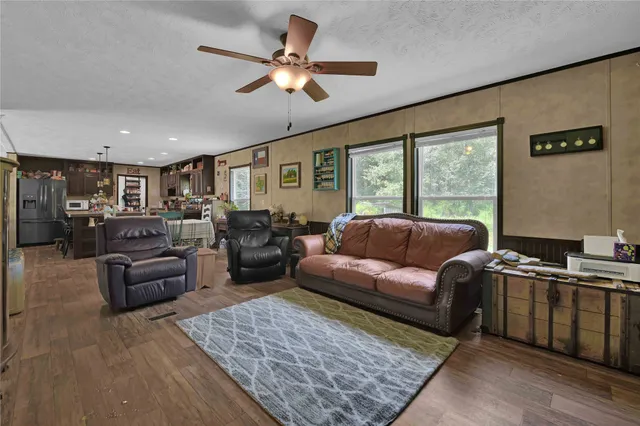 a living room with furniture ceiling fan and a rug