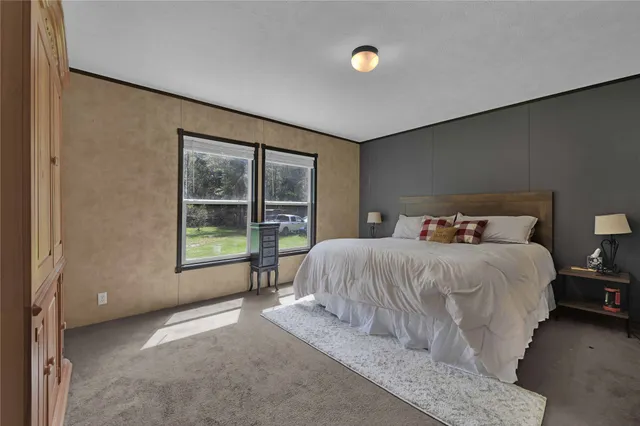 a bedroom with a bed and window