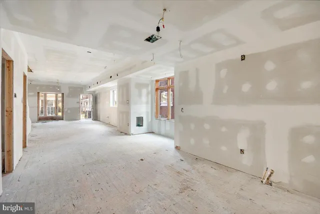 a view of a big room with chandelier and windows