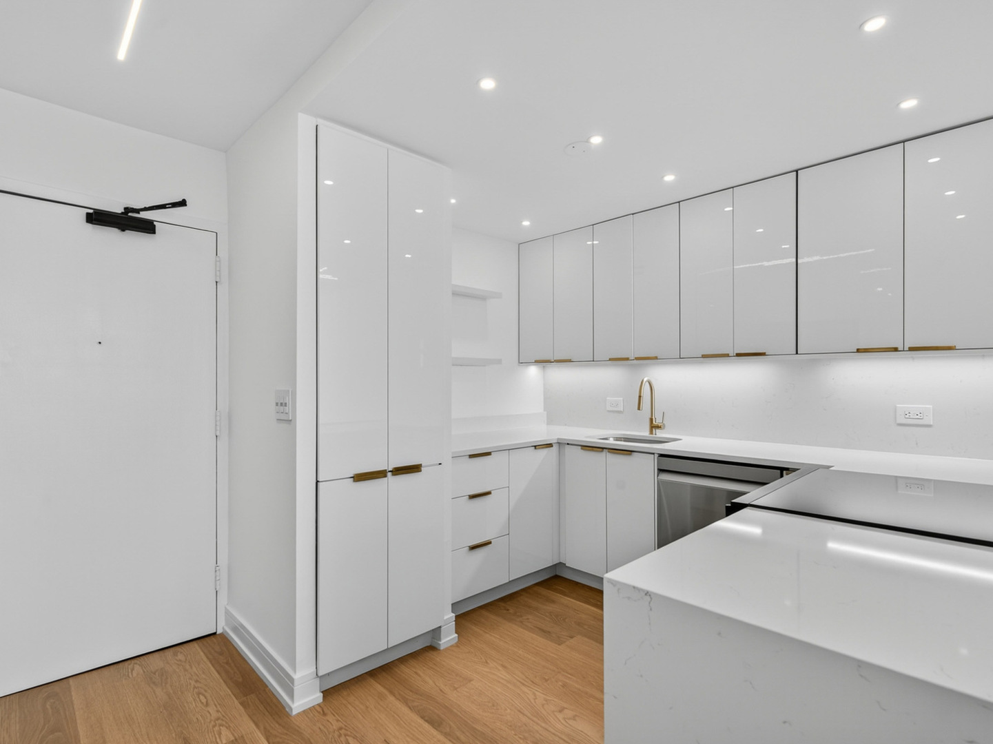 1455 North Sandburg Terrace, Unit 2403 Chicago, IL 60610 - Photo 13 of 22 a kitchen with white cabinets and white appliances